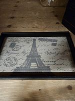 Top view of tray showing Eiffel Tower canvas insert within black wood frame