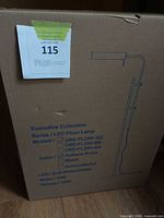 Sealed box showing product line and illustration of floor lamp