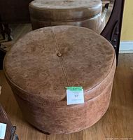 Full view of round faux leather ottoman top and sides