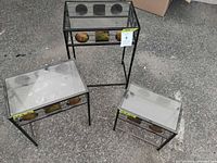 Overview of all three metal and glass side tables showing design and condition
