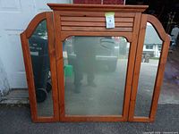 Front view showing three glass panels and wood frame