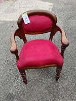 Front view of red upholstered Victorian-style armchair