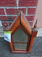 Front view showing pointed arch, mirror, finials, overall condition