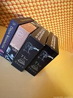 Four cardboard slipcases standing, showing spine titles and Verve branding