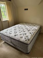 Full view of Kingsdown queen pillow-top mattress on box spring and steel frame