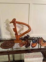 Group shot of all eight wooden items on glass shelf