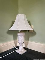 Full view of marble table lamp with shade, cord visible