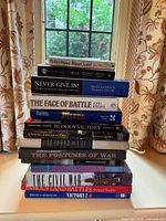 Full stack of 12 military history books, spines facing camera
