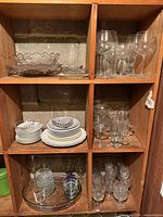 shelving with entire assortment of glassware and porcelain plates
