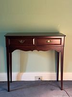 Front view of mahogany hall table showing drawers, legs, overall condition