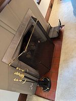 Fireplace screen, tool set on stand, log holder in situ