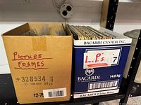 Two boxes labelled Picture Frames and LPs on shelf