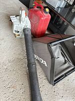 Echo PB-200 blower with fuel can and Honda bag on floor