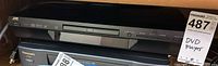 Front view of JVC DVD player showing disc tray and controls