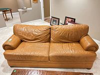 Front view showing overall style, cushions, leather condition