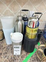 Group of mixed drinkware items on countertop showing quantity and variety