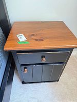 Top and front view showing drawer and door design, distressing, knobs, lot sticker