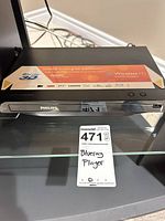 Front and top view of Philips Blu-ray player showing decal and overall condition