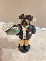 Front view of bulldog butler figurine with tray and sign