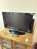 Front view of Samsung 32-inch LCD TV on stand with power cord