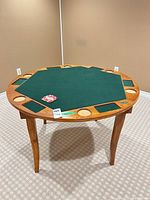 Full view of Sportcraft poker table showing wood frame, green felt octagon, cup holders