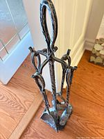 Full view of fireplace tool set on stand