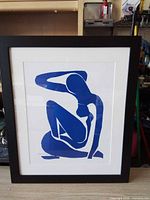 Front view showing blue nude print, mat, frame