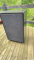 Cabinet with grille attached on wooden deck