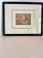 front view showing print, mat, black wood frame