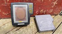 Front view of Humminbird TCR ID-1 display beside gray transducer housing