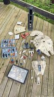 Group shot of all figures, vehicles, carry case and parts laid out on deck