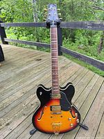Full front view of Peavey semi-hollow guitar on stand