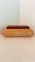 Front view showing light oak base and reddy brown lid