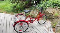 Left side view of full tricycle, showing frame, basket, wheels and condition
