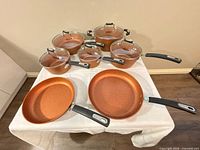 Full set displayed on table showing all pots, pans and lids