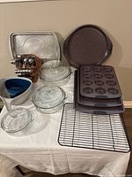 All items grouped: knife block set, bakeware, casseroles, colanders, sheet pan