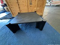 Full view of square black coffee table on moving blanket