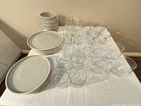 Overall view of plates, bowls and assorted glassware on table