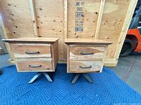 Front view of both nightstands showing drawer fronts and metal X bases