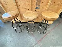 Three tan leather bar stools top view