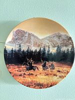 Front of collector plate showing sunrise scene with riders