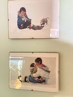 Both framed prints hanging on wall