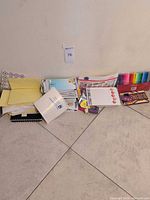 Overall lot including envelopes, notebooks, marker set, colored pencils, notepad, stickers