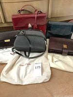 Group shot of all five handbags with dust bags visible