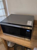 Front view of Panasonic stainless/black microwave showing door and control panel