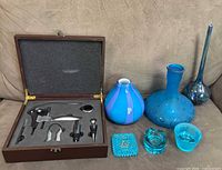 Open wooden wine tool box and all six glass items displayed