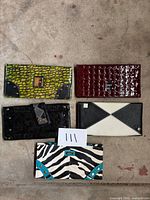 Five Miche handbag covers laid out showing all patterns and conditions