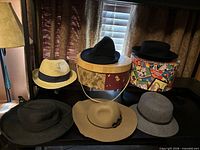 All six hats displayed with two hat boxes