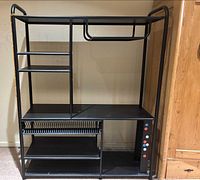 Full view of black metal media/TV stand showing shelves, CD rack, side panel