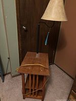 Full view of table with lamp and magazine rack